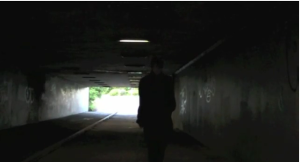 A screenshot of Staker walking down an underpass